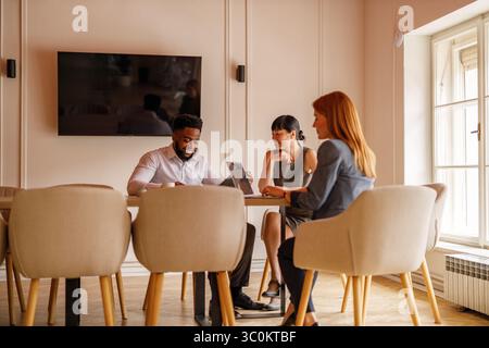 Team of professionals discussing and planning in office during meeting collaborating on strategies and business goals Stock Photo