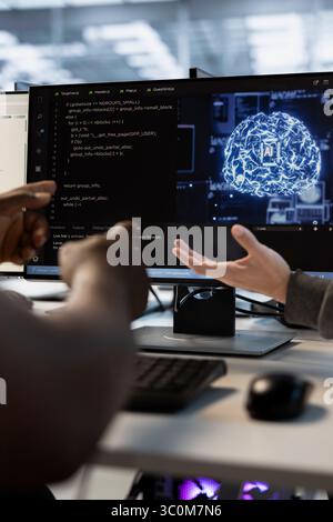 AI programmer in data center optimizing IT infrastructure using network management skills. Artificial intelligence server room professional upgrading gear, reducing operational costs Stock Photo
