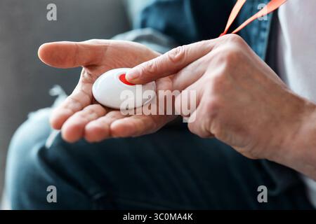 Closeup Of Man's Hand Pressing Alarm Button For Emergency Stock Photo