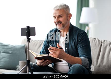 Happy elderly man studying online while staying home Stock Photo