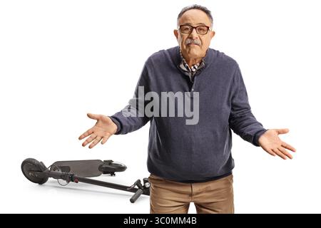 Confused mature man with an electric scooter isolated on white background Stock Photo
