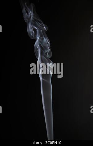 Abstract figure created by white smoke on an isolated black background to stimulate the subconscious with truly beautiful shapes Stock Photo