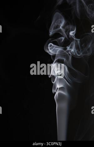 Abstract figure created by white smoke on an isolated black background to stimulate the subconscious with truly beautiful shapes Stock Photo