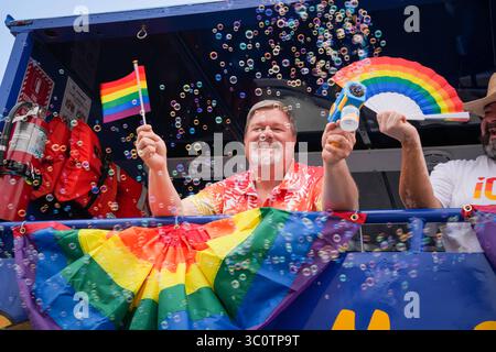 July 19, 2025, San Diego, California, United States: A joyful man beams from a float decorated with rainbow flags, holding a mini Pride flag and a bubble blower. Surrounded by bubbles and vibrant colors, he radiates celebration and LGBTQ+ pride. Participants marched during the San Diego Pride Parade, in San Diego, California. Thousands attended the annual LGBTQ+ celebration, which included floats, dancers, and community organizations. (Credit Image: © Alvaro Diaz/SOPA Images via ZUMA Press Wire) EDITORIAL USAGE ONLY! Not for Commercial USAGE! Stock Photo