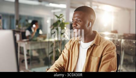 Graphic designer, music and man in office on computer for web development, website and ui design. Creative agency, digital tech and person with Stock Photo