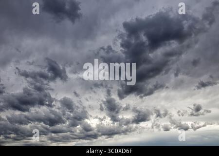 Dramatic dark and ominous storm clouds filling the sky on an overcast day. Stock Photo