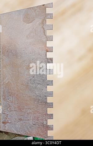notched trowel close-up for repairing walls and ceilings Stock Photo
