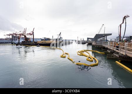 January 4, 2019 - Seattle, Washington, United States - Seattle, Washington: An excavator loads rock from a barge to the shoreline during construction at Colman Dock. The ferry terminal is Washington Stateâ€™s largest, transporting 10 million visitors annually across Puget Sound between downtown Seattle and Kitsap County and the Olympic Peninsula. Washington State Department of Transportationâ€™s Seattle Multimodal Terminal at Colman Dock Project started construction a new multimodal terminal in August 2017 and is expected to be complete sometime in 2023. (Credit Image: © Paul Christian Gordon/ Stock Photo