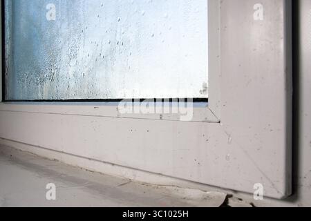 humidity and dampness on the window. The paint is coming off on the windowsill Stock Photo
