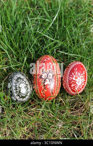 Traditional hand-dyed and hand-painted Easter eggs on the green grass in Poland called pisanka or kroszonka or kraszonka, Poland, Europe Stock Photo