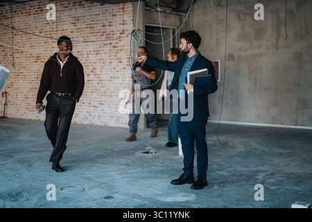 Business professionals and contractors inspecting an unfinished construction site for project evaluation Stock Photo