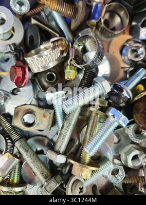 Industrial Fastener Mix – Bolts, Screws, Nuts & Washers Piled Together Stock Photo