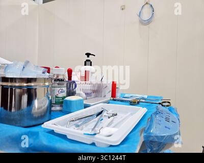 Sterile Dental Instruments and Supplies on Blue Draped Table in Modern Clinic Stock Photo