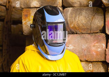 A man in a protective chemical suit and a welding mask on his head. Stock Photo