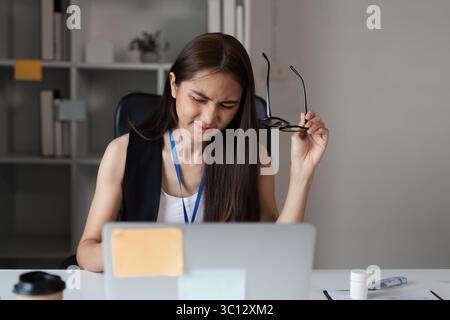 Stressed Office Workers Struggling with Workload and Deadlines in a Modern Corporate Environment Stock Photo