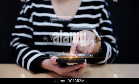 Woman chatting with ai Artificial Intelligence on mobile phone from using online technology application. Chat with an intelligent bot asks Stock Photo