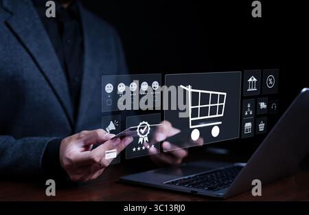 Payment and shopping online concept. Businessman using computer to enter purchase order into shopping cart and using mobile phone with credit card Stock Photo