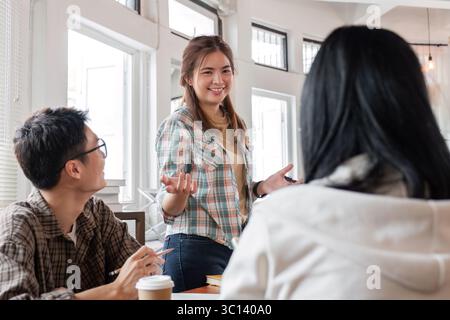 Diverse Group of Students Collaborating on Homework in a Bright Modern Study Space Stock Photo