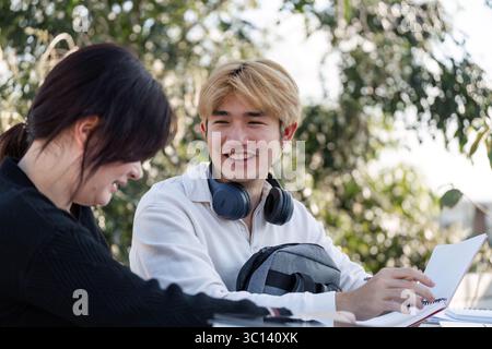 High School Students Collaborate on Homework and Projects in a Relaxed Outdoor Setting After School Hours Stock Photo