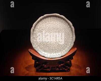 close view to the white porcelain with crackle glaze under the light in the museum for show Stock Photo