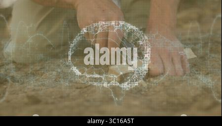 Hands carving soil with hand tool in dry sandy cracked earth outdoors, with wireframe grid overlay Stock Photo