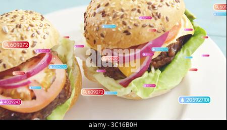 Displaying two cheeseburgers resting on ceramic plate on blue tabletop, with digital numeric tags Stock Photo