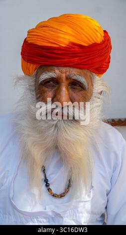 An old Indian man, with thick white beard, looking thoughtful, pensive, in Jaipur, Rajasthan, India Stock Photo
