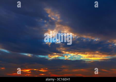 Dramatic sunset cloudscape with colorful clouds. Clouds illuminated by the setting sun, creating a captivating panorama. Beautiful twilight Stock Photo