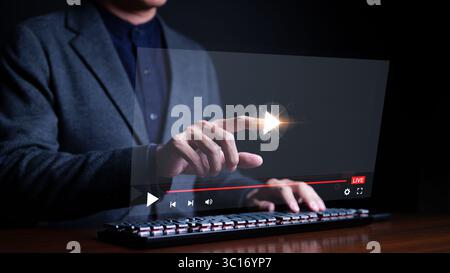 Man watching watching video on internet or streaming online on computer. live concert, show or tutorial, tv series, watching online movie, digital Stock Photo