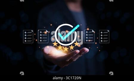 Quality assurance concept. Businessman holding and showing best quality assurance with golden five stars for guarantee product Stock Photo