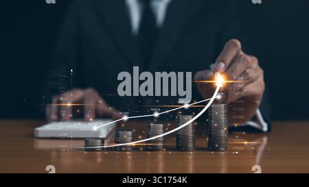 Financial investment and make money concept. Businessman hand drawing virtual increase graph with money coins stacking. Business growth chart, profits Stock Photo