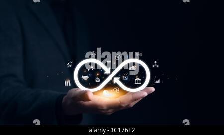 Technology data link concept. Businessman hand holding virtual infinity with business technology icon for sign of connection to community metaverse Stock Photo