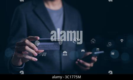 Man using smartphone and credit card pay via mobile banking app for online payment with digital money technology icons. Online shopping, Financial Stock Photo