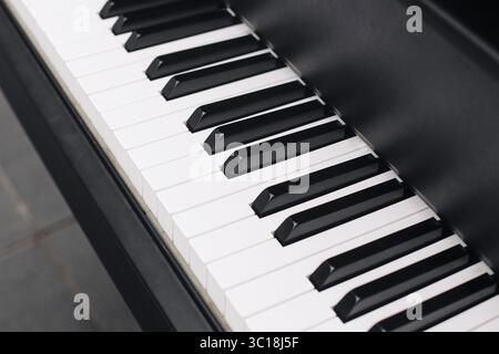 Piano keyboard closeup. Black and white keys of classical instrument. Music background with elegant detail. Harmony and melody creation concept. Stock Photo