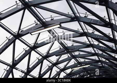 Geometric grid of glass panels and metal supports, viewed from inside ...
