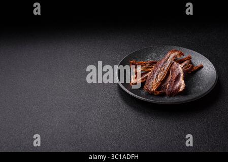 Dried salted fish as snacks or jerky, seafood as slices. Dried seafood snacks as a background for your design Stock Photo