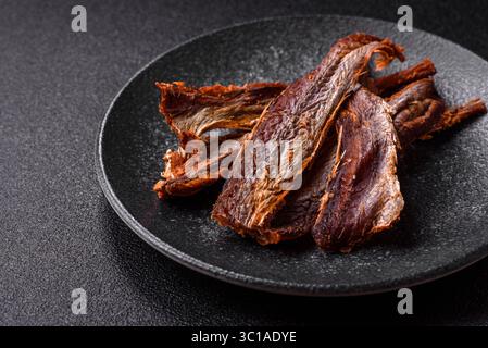Dried salted fish as snacks or jerky, seafood as slices. Dried seafood snacks as a background for your design Stock Photo