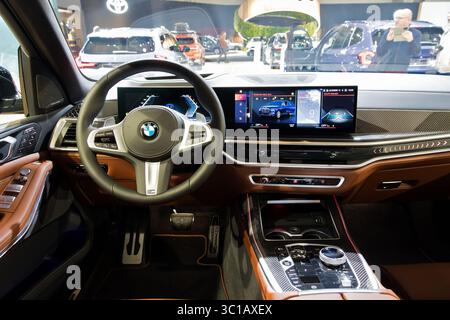 Interior of a BMW X7 luxury SUV showcasing premium leather seats and a digital dashboard at the Brussels Motor Show. Brussels, Belgium - January 10, 2 Stock Photo