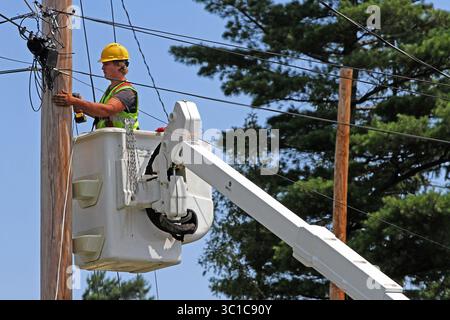 July 31, 2012 - Two Harbors, Minn, MN - Minnesota, U.S. - Seth Kern, with Lake States Construction, a sub-contractor of Lake Connections, readied telephone poles in Two Harbors to string stainless steel strand cables from which fiber optic cable will be lashed to on 7/31/12. By the time the communications project is done in 2014 around 2000 miles of fiber optic cable will be strung, connecting customers with broadband internet, video and telephone service. /Star Tribune (Credit Image: Bruce Bisping/Minneapolis Star Tribune/TNS via ZUMA Wire) Stock Photo