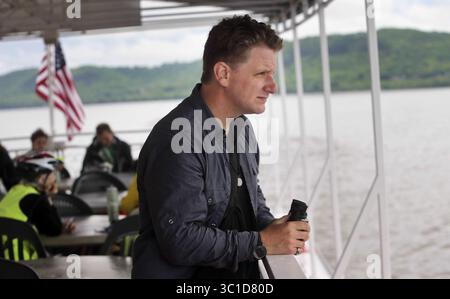June 6, 2014 - Lake City, MN, U.S. - Author Chad Lewis of Wisconsin, who has written a book about the legend of Pepie and is also an adventurer and lecturer and travels the world trying to prove lore, with binocualrs ready, scans the waters Saturday, June 8, 2014, on Lake Pepin near Lake City, MN. (DAVIDJOLES/STARTRIBUNE) Lake Pepin has a sea creature. Or had. Or has had several. From, the time of Father Hennepin until last year, ''something'' has been sighted, or sensed, or imagined. There's a $50,000 reward - yet unclaimed - but for all the tourists looking for fun, there are cryptozoologist Stock Photo
