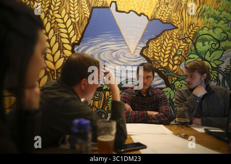 January 30, 2018 - Minneapolis, MN, U.S.A - Amanda Eldridge, Chris Larson, Dan Kinney, and Jacob Hexum, from left, all were involved in discussion of the water treatment project the group is designing and building in Honduras while at an Engineers Without Borders meeting at 612 Brew. ....The Minnesota chapter of Engineers Without Borders, a group of highly educated men and women who use their free time designing and building systems to help communities in developing nations, is now helping a small mountain village in Honduras build a new water treatment system that cleans and stores water. The Stock Photo