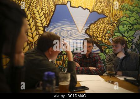 January 30, 2018 - Minneapolis, MN, U.S.A - Amanda Eldridge, Chris Larson, Dan Kinney, and Jacob Hexum, from left, all were involved in discussion of the water treatment project the group is designing and building in Honduras while at an Engineers Without Borders meeting at 612 Brew. ....The Minnesota chapter of Engineers Without Borders, a group of highly educated men and women who use their free time designing and building systems to help communities in developing nations, is now helping a small mountain village in Honduras build a new water treatment system that cleans and stores water. The Stock Photo