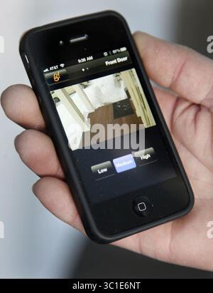 Feb. 8, 2011 - Golden Valley, MN, U.S. - Â 8, 2011 - Golden Valley, MN - IN THIS PHOTO: Rocky Digiacomo demonstrated how to use an Iphone App to operate the new homes he is building in Golden Valley. The image on the phone is the video surveillance from the front door. (Credit Image: Elizabeth Flores/Minneapolis Star Tribune/TNS via ZUMA Wire) Stock Photo