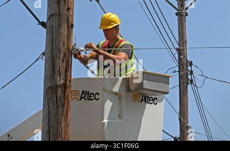 July 31, 2012 - Two Harbors, Minn, MN - Minnesota, U.S. - Seth Kern, with Lake States Construction, a sub-contractor of Lake Connections, readied telephone poles in Two Harbors to string stainless steel strand cables from which fiber optic cable will be lashed to on 7/31/12. By the time the communications project is done in 2014 around 2000 miles of fiber optic cable will be strung, connecting customers with broadband internet, video and telephone service. /Star Tribune (Credit Image: Bruce Bisping/Minneapolis Star Tribune/TNS via ZUMA Wire) Stock Photo