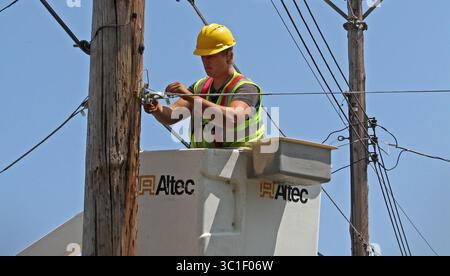 July 31, 2012 - Two Harbors, Minn, MN - Minnesota, U.S. - Seth Kern, with Lake States Construction, a sub-contractor of Lake Connections, readied telephone poles in Two Harbors to string stainless steel strand cables from which fiber optic cable will be lashed to on 7/31/12. By the time the communications project is done in 2014 around 2000 miles of fiber optic cable will be strung, connecting customers with broadband internet, video and telephone service. /Star Tribune (Credit Image: Bruce Bisping/Minneapolis Star Tribune/TNS via ZUMA Wire) Stock Photo