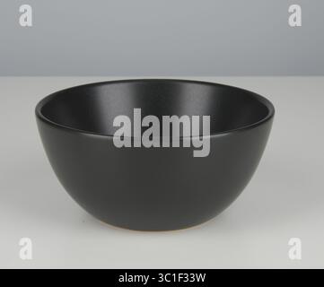Matte black ceramic cup isolated nature background with clipping path Stock Photo
