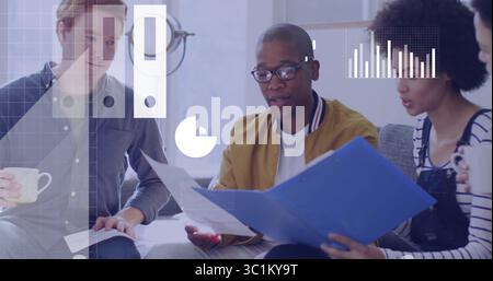 Reviewing documents from blue folder, team sitting on gray sofa in modern office lounge, with mugs Stock Photo