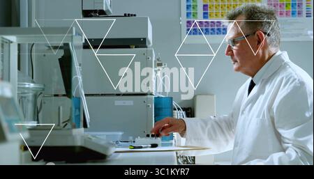 Senior male scientist pipetting samples at laboratory bench, with instrument modules, copy space Stock Photo