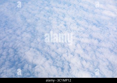 Textured blanket of puffy clouds, seen from above. Panoramic view of the sky, filled with a multitude of fluffy clouds Stock Photo