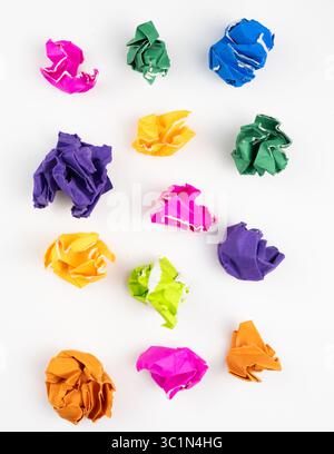 Vertical background with Colorful Crumpled Paper Balls in Various Shades of Purple, Pink, Green, Yellow, and Orange Isolated on White Background for C Stock Photo